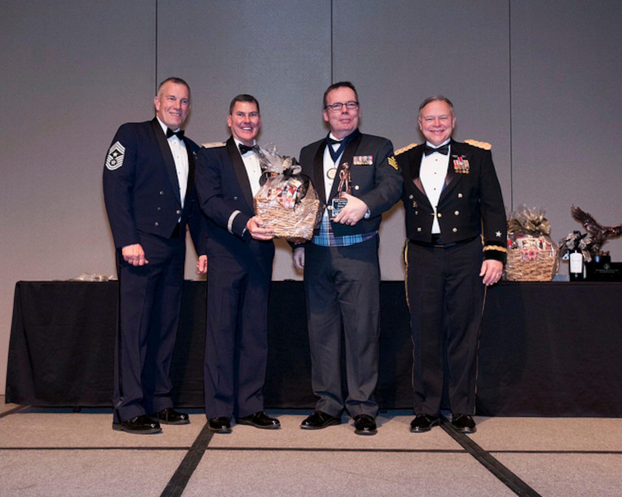 Royal Canadian Air Force Sgt. Yves Truchon of the 225th Air Defense Squadron wins the Honor Guard Member of the Year award at the Washington Air National Guard 8th Annual Awards Banquet.  Pictured from right to left are: Maj. Gen. Brett Daugherty, The Adjutant General, Washington; RCAF Sgt. Yves Truchon; Brig. Gen. John Tuohy, the Assistant Adjutant General - Air, Washington; and Chief Master Sgt. Max Tidwell, WA ANG Command Chief. (U.S. Air Force photo by Tech. Sgt. Michael Brown) 