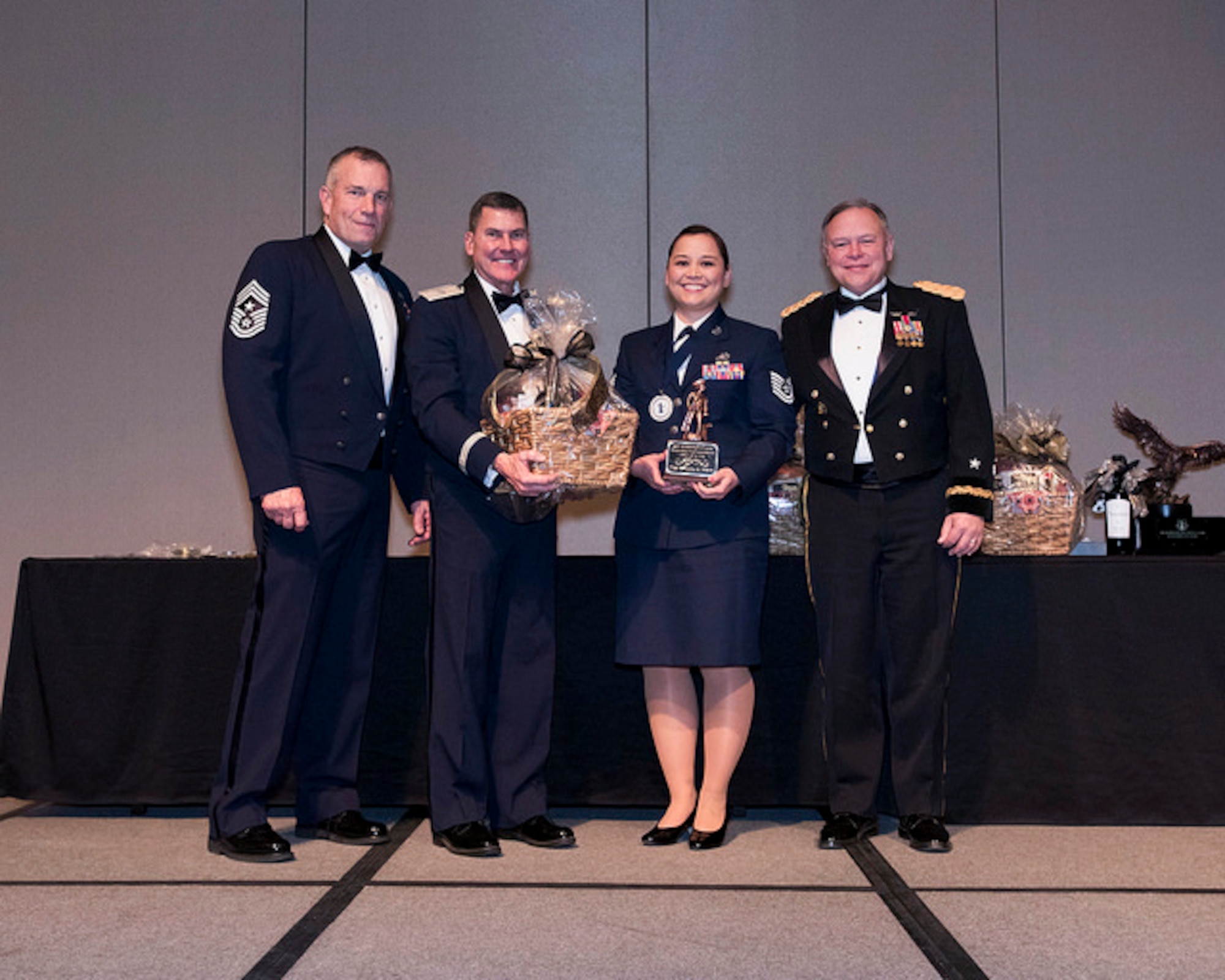 Tech. Sgt. Rivanita Noyes of the 225th Air Defense Squadron wins NCO of the Year during the Washington Air National Guard 8th Annual Awards banquet.  Pictured from right to left are: Maj. Gen. Brett Daugherty, The Adjutant General, Washington; Tech. Sgt. Rivanita Noyes; Brig. Gen. John Tuohy, the Assistant Adjutant General - Air, Washington; and Chief Master Sgt. Max Tidwell, WA ANG Command Chief.  (U.S. Air Force photo by Tech. Sgt. Michael Brown)