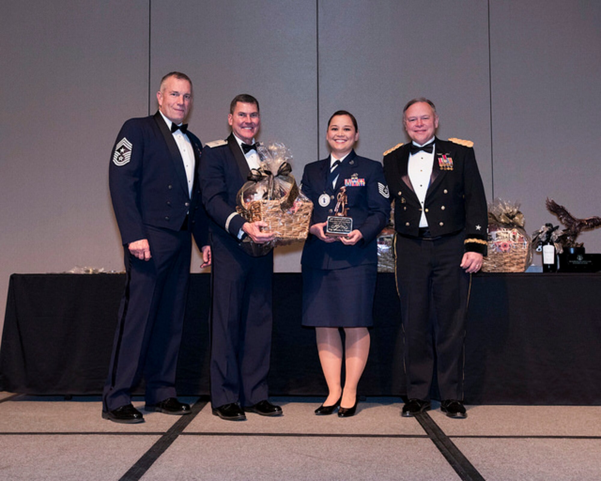Tech. Sgt. Rivanita Noyes of the 225th Air Defense Squadron wins NCO of the Year during the Washington Air National Guard 8th Annual Awards banquet.  Pictured from right to left are: Maj. Gen. Brett Daugherty, The Adjutant General, Washington; Tech. Sgt. Rivanita Noyes; Brig. Gen. John Tuohy, the Assistant Adjutant General - Air, Washington; and Chief Master Sgt. Max Tidwell, WA ANG Command Chief.  (U.S. Air Force photo by Tech. Sgt. Michael Brown)