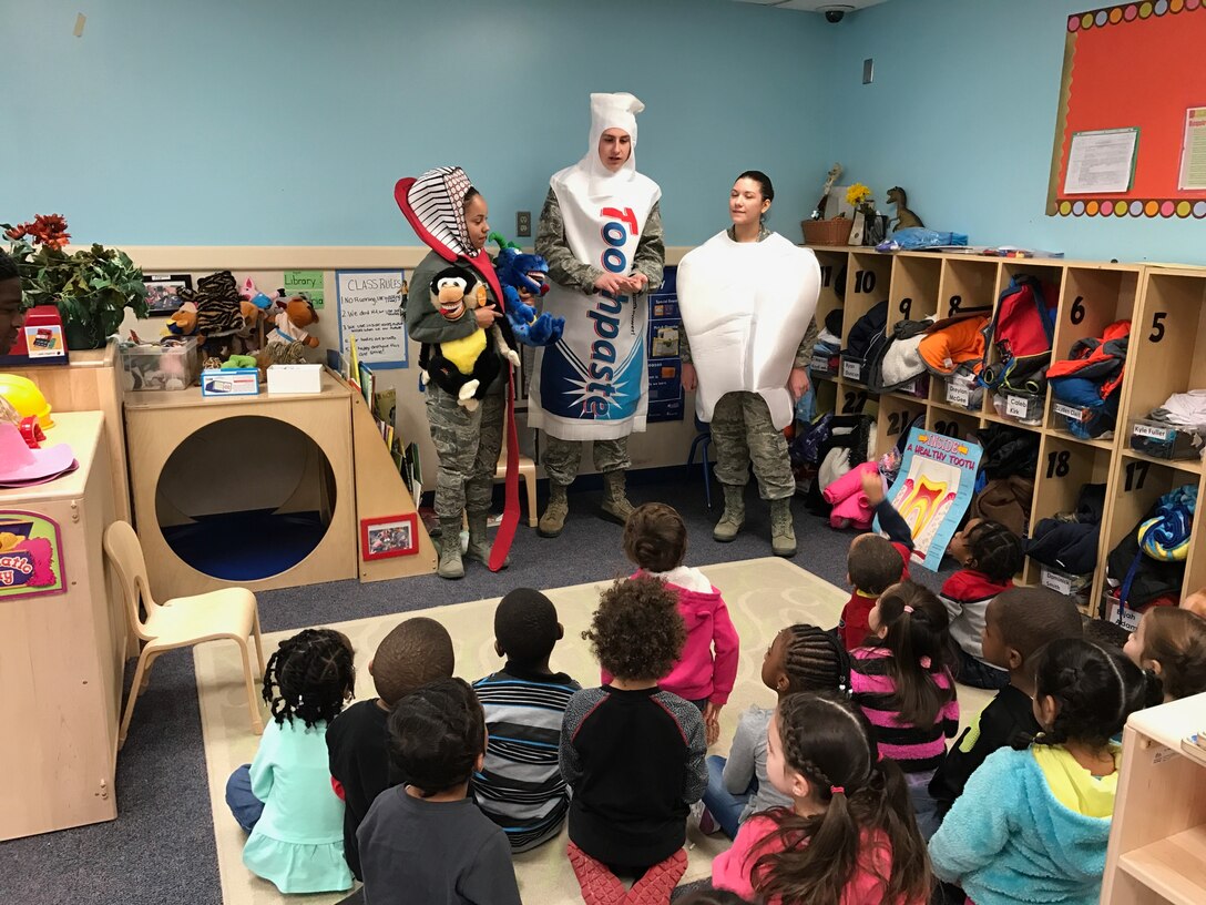 As part of National Children's Dental Health Month, members of the 779th Dental Squadron spoke with children about brushing, flossing and eating healthy snacks. (U.S. Air Force photo by Senior Airman Delano Scott)