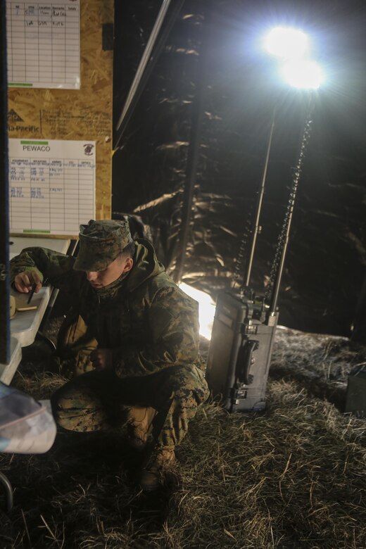Lance Cpl. Niko Richardson waits to receive communication from patrols reporting back to a forward operating base at Camp Lejeune, N.C., Feb. 9, 2017. During the monthly field exercise, Marines practiced company-level operations such as tactical site exploitation, mounted and dismounted patrols and detainee operations. Richardson is with Law Enforcement Battalion, II Marine Expeditionary Force Headquarters Group. (U.S. Marine Corps photo by Lance Cpl. Miranda Faughn)