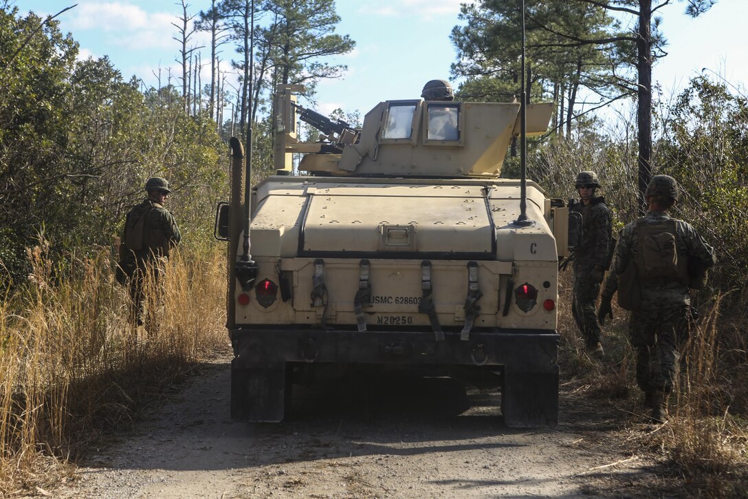 Marines dismount to collect further information after having encountered an unknown suspect on a mounted patrol at Camp Lejeune, N.C., Feb. 9, 2017. Marines participated in a monthly field exercise where they practiced company level operations as well as tactical site exploitation and detainee operations. The Marines are with Law Enforcement Battalion, II Marine Expeditionary Force Headquarters Group. (U.S. Marine Corps photo by Lance Cpl. Miranda Faughn)