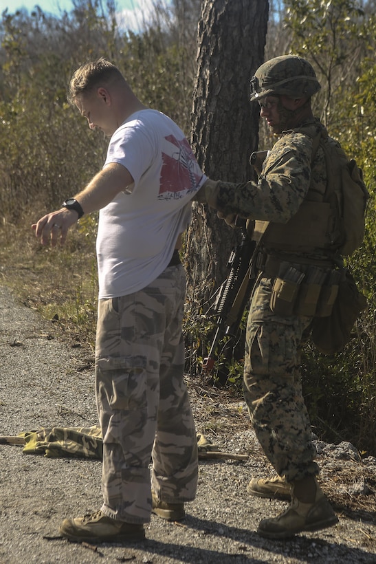 A Marine pats down a notional suspect at Camp Lejeune, N.C., Feb. 9, 2017. During a monthly field exercise, Marines practiced questioning suspects and detaining who they deemed harmful. This exercise is to help them practice skill sets they might use in deployed environments. This Marine is with Law Enforcement Battalion, II Marine Expeditionary Force Headquarters Group. (U.S. Marine Corps photo by Lance Cpl. Miranda Faughn)