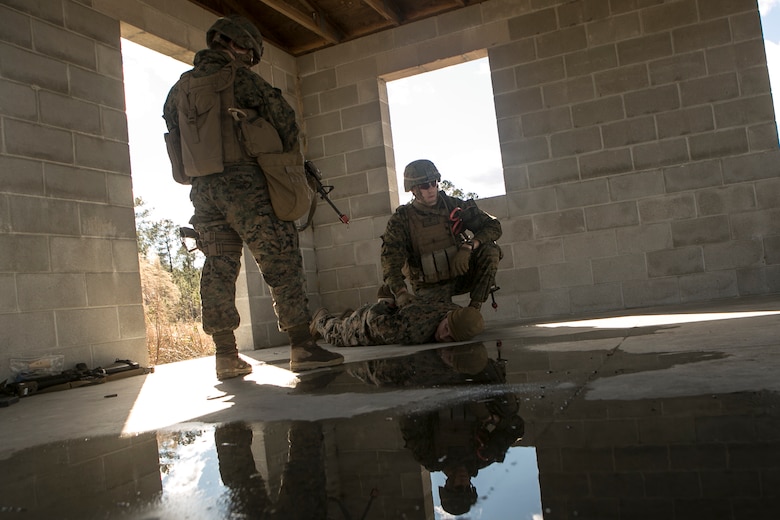 Marines detain a suspect during a notional raid after receiving intelligence of suspicious activity at Camp Lejeune, N.C., Feb. 9, 2017. Marines took part in a monthly field exercise where they practiced company-level operations as well as tactical site exploitation, mounted and dismounted patrols, and detainee operations.  These Marines are with Law Enforcement Battalion, II Marine Expeditionary Force Headquarters Group. (U.S. Marine Corps photo by Lance Cpl. Damarko Bones)
