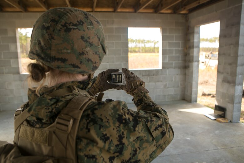 A Marine gathers evidence of counter-intelligence forces as part of a monthly field exercise at Camp Lejeune, N.C., Feb. 9, 2017. Marines conducted a patrol after receiving intelligence regarding adversaries collecting information on their forward operating base. During the raid, the Marines were able to practice with detainee and tactical site exploitation operations. This Marine is with Law Enforcement Battalion, II Marine Expeditionary Force Headquarters Group. (U.S. Marine Corps photo by Lance Cpl. Demarko Bones)