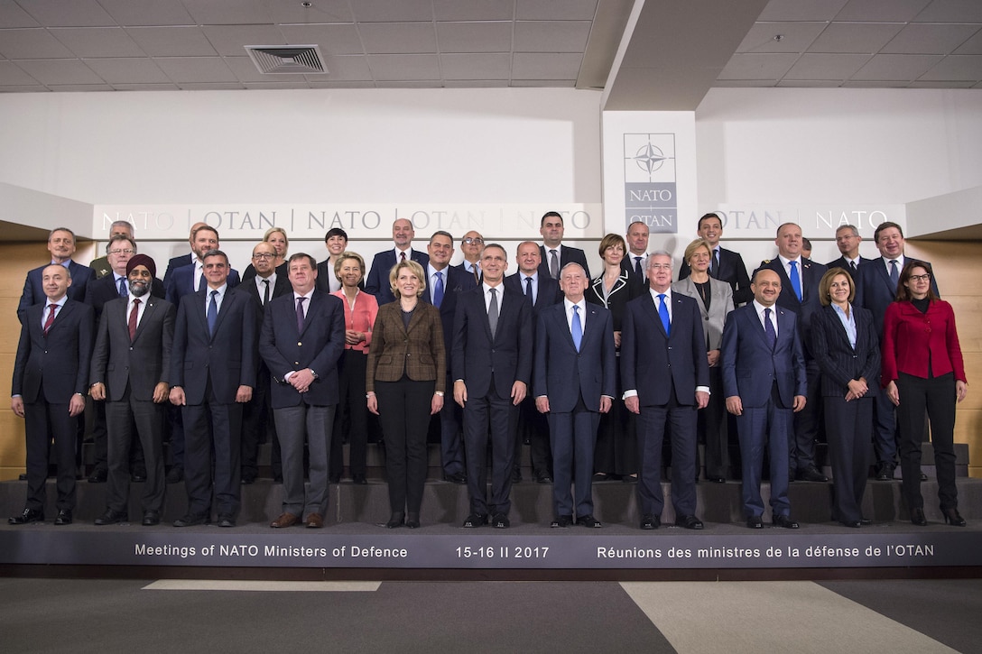 Defense Secretary Jim Mattis, front row, center right, and fellow defense ministers pose for a photo at NATO headquarters.