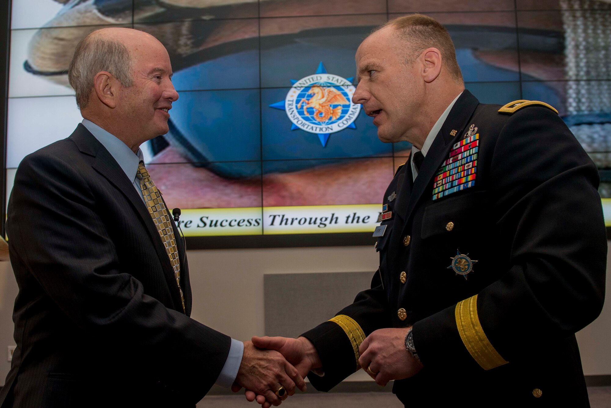 Army Lt. Gen. Stephen Lyons, U.S. Transportation Command deputy commander, presents the 30-4-30 USTRANSCOM coin to Retired Air Force Gen. Duncan McNabb during the Distinguished Speaker Series, an initiative to celebrate the command’s 30th anniversary in October 2017. McNabb was the USTRANCOM commander from 2008 – 2011. (U.S. Air Force photo/ Senior Airman Joshua Eikren)
