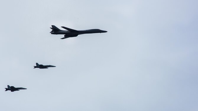 A B-1B Lancer from Anderson Air Force Base in Guam and two F/A-18E Super Hornets from the “Golden Dragons” of Strike Fighter Squadron (VFA) 192 fly over the aircraft carrier USS Carl Vinson (CVN 70) as it transits the Philippine Sea. The B-1s are deployed in support of U.S, Pacific Command’s Continuous Bomber Presence mission. In place since 2004, the CBP missions are conducted by U.S. Air Force bombers such as the B-1, B-52 Stratofortress and B-2 Spirit in order to provide non-stop stability and security in the Indo-Asia-Pacific region.  The Carl Vinson Strike Group is on a regularly scheduled Western Pacific deployment as part of the U.S. Pacific Feet-led initiative to extend the command and control functions of U.S. 3rd Fleet. U.S. Navy aircraft carrier strike groups have patrolled the Indo-Asia-Pacific regularly and routinely for more than 70 years. (U.S. Navy Photo by Seaman Jake Cannady)