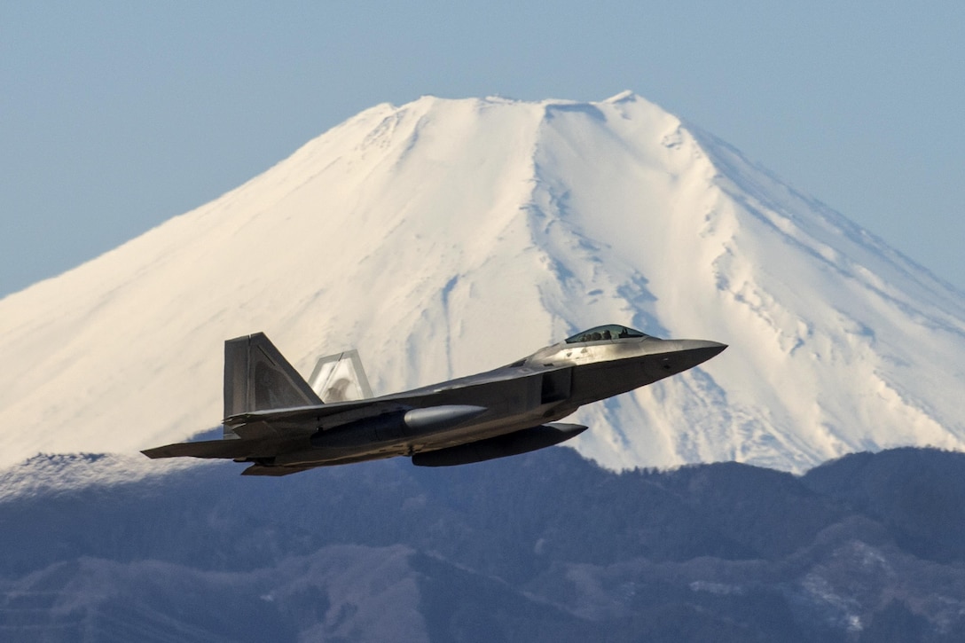 An Air Force F-22 Raptor takes off at Yokota Air Base, Japan, Feb. 13, 2017, as Mount Fuji looms behind. F-22 Raptors stopped at the base before traveling to an Australian base. The pilot and aircraft are assigned to the 90th Fighter Squadron and deployed from Joint Base Elmendorf-Richardson, Alaska. Air Force photo by Yasuo Osakabe
