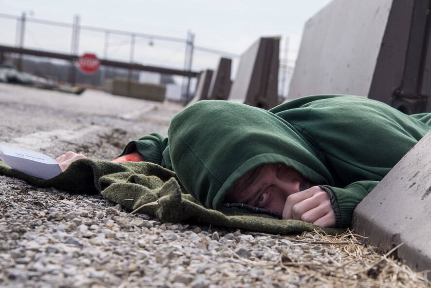 Airman Austin Gorham, 15th Operational Weather Squadron weather forecaster, acts as a victim of an explosion during an exercise at Scott Air Force Base, Illinois, Feb. 9, 2016. This was an exercise to test Scott's response to an explosion with potential chemical, biological, radiological and nuclear contamination. (U.S. Air Force photo by Airman 1st Class Daniel Garcia)