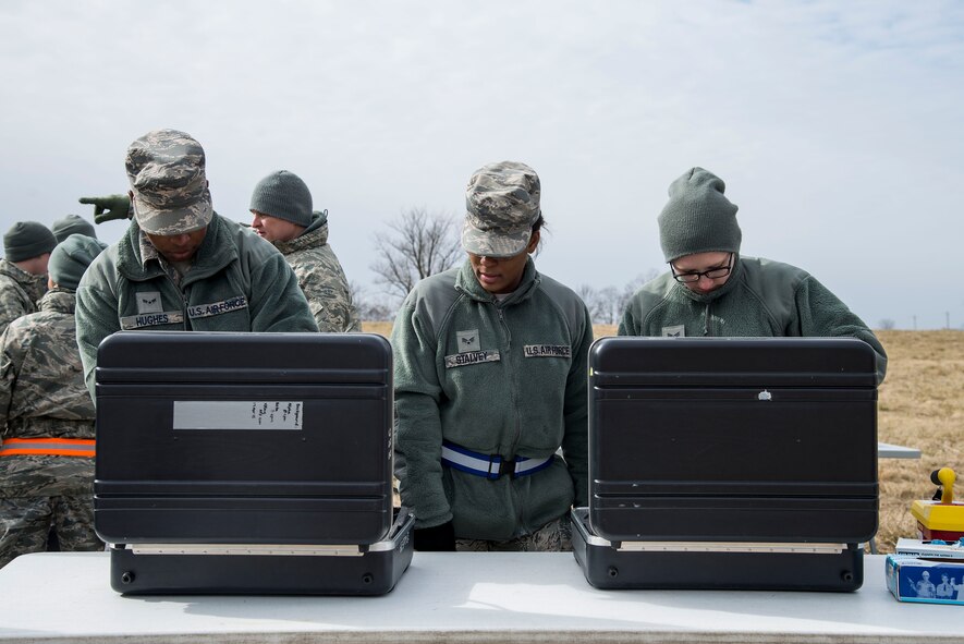 (Left to right) Airman 1st Class Keyman Hughes, 375th Aerospace Medicine Squadron bioenvironmental egineering technician, Senior Airman Veronica Stalvey, 375th AMDS public health technician, and Natalie Lafferty, 375th AMDS bioenvironmental engineering technician, monitor patients who may be contaminated with radiation allowing patients with high exposure to be decontaminated to prevent spreading contamination during an exercise at Scott Air Force Base, Illinois, Feb. 9, 2016. This was an exercise to test Scott's response to an explosion with potential chemical, biological, radiological and nuclear contamination. (U.S. Air Force photo by Airman 1st Class Daniel Garcia)