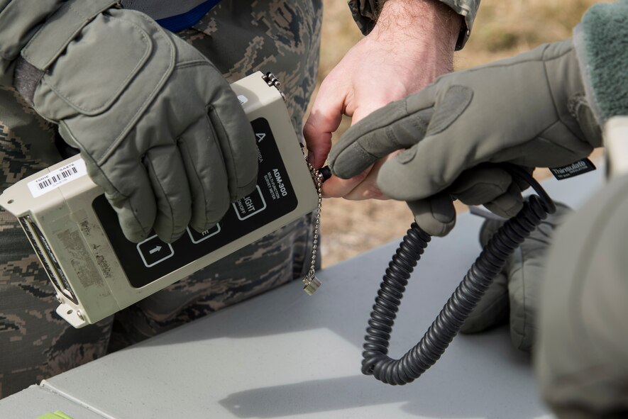 Members of Emergency Management prepare to attach a probe to the AMD-300, a radiation detection device designed to detect, measure, and digitally display levels of gamma radiation during an exercise at Scott Air Force Base, Illinois, Feb. 9, 2016. This was an exercise to test Scott's response to an explosion with potential chemical, biological, radiological and nuclear contamination. (U.S. Air Force photo by Airman 1st Class Daniel Garcia)