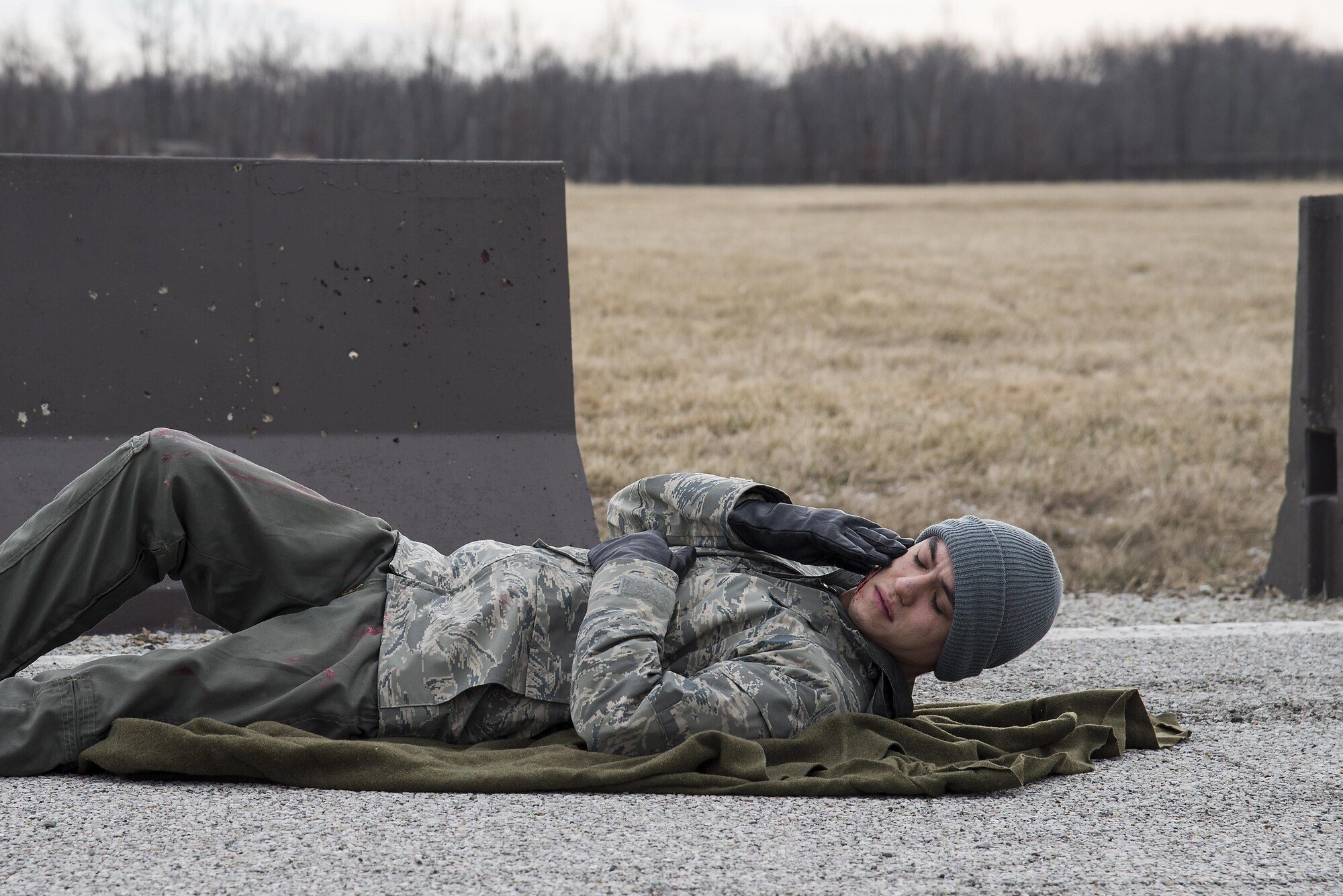 Airman Isaiah Martin, 15th Operational Weather Squadron weather forecaster, acts as a victim of an explosion during an exercise at Scott Air Force Base, Illinois, Feb. 9, 2016. This was an exercise to test Scott's response to an explosion with potential chemical, biological, radiological and nuclear contamination. (U.S. Air Force photo by Airman 1st Class Daniel Garcia)