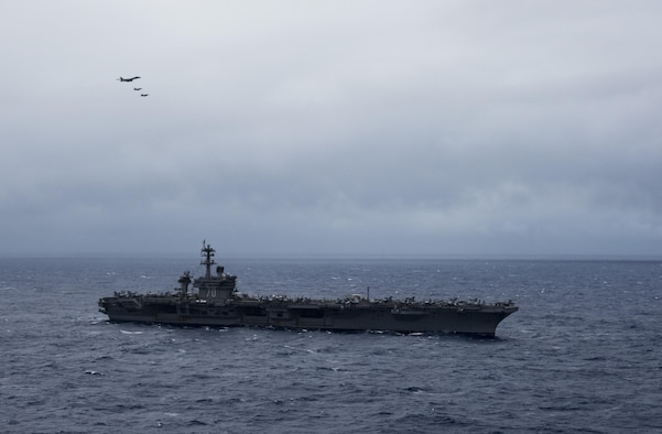 A B-1B Lancer from Anderson Air Force Base in Guam flies over the aircraft carrier USS Carl Vinson (CVN 70) as it transits the Philippine Sea.  The B-1s are deployed in support of U.S, Pacific Command’s Continuous Bomber Presence mission. In place since 2004, the CBP missions are conducted by U.S. Air Force bombers such as the B-1, B-52 Stratofortress and B-2 Spirit in order to provide non-stop stability and security in the Indo-Asia-Pacific region. The Carl Vinson Strike Group is on a regularly scheduled Western Pacific deployment as part of the U.S. Pacific Feet-led initiative to extend the command and control functions of U.S. 3rd Fleet. U.S. Navy aircraft carrier strike groups have patrolled the Indo-Asia-Pacific regularly and routinely for more than 70 years. (U.S. Navy Photo by Petty Officer 3rd Class Kurtis A. Hatcher)