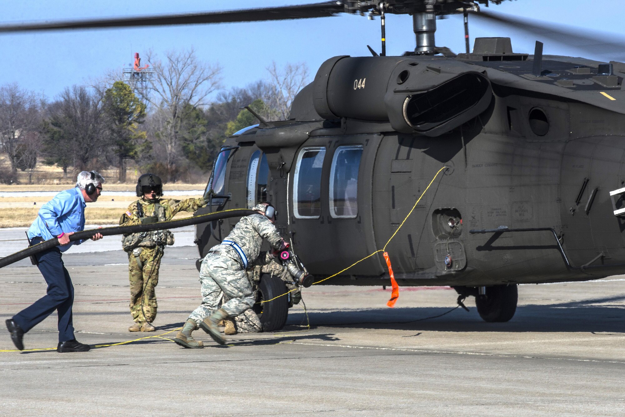 Scott Air Force Base Airmen recently received training for "hot refueling". The training provides aircrews with procedures specific to "hot refueling" operations, with the helicopter running while refueling, versus "cold refueling" where the helicopter is completely shut down prior to receiving fuel. With this two-person operation, one would concentrate on the fueling portion, such as connecting the bonding cable, deploying the fueling hose, and controlling the fueling while the other would remain in eye sight of both the refueler and a flight crew members. Having the choice to "hot refuel" adds to the readiness of the day to day operations and is highly helpful for practice down range when there's not enough time to shut down to refuel. (U.S. Air Force photos/Senior Airman Tristin English)