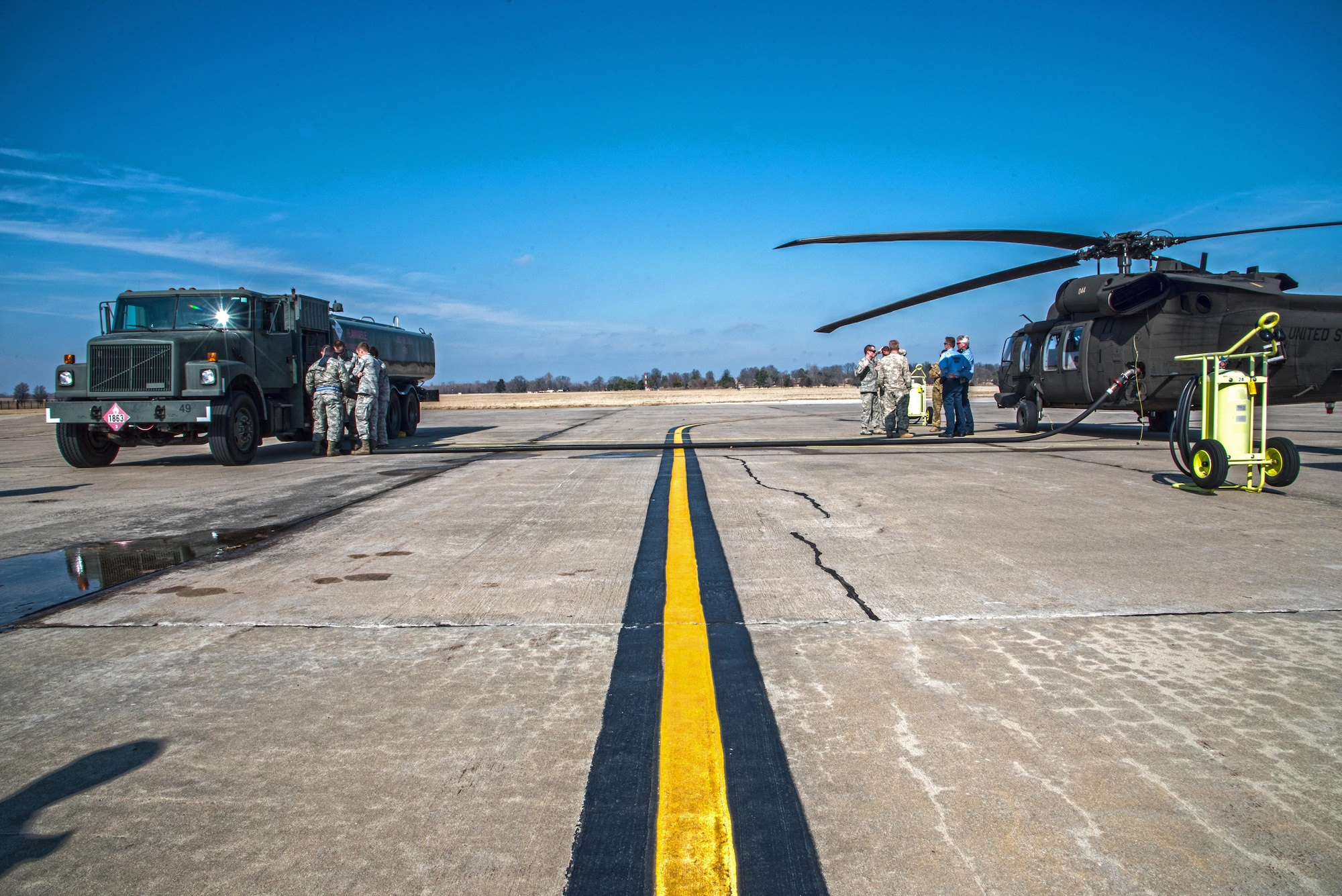 Scott Air Force Base Airmen recently received training for "hot refueling". The training provides aircrews with procedures specific to "hot refueling" operations, with the helicopter running while refueling, versus "cold refueling" where the helicopter is completely shut down prior to receiving fuel. With this two-person operation, one would concentrate on the fueling portion, such as connecting the bonding cable, deploying the fueling hose, and controlling the fueling while the other would remain in eye sight of both the refueler and a flight crew members. Having the choice to "hot refuel" adds to the readiness of the day to day operations and is highly helpful for practice down range when there's not enough time to shut down to refuel. (U.S. Air Force photos/Senior Airman Tristin English)