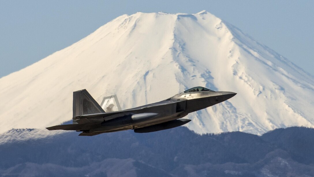 An Air Force F-22 Raptor takes off at Yokota Air Base, Japan, Feb. 13, 2017, as Mount Fuji looms behind. F-22 Raptors stopped at the base before traveling to an Australian base. The pilot and aircraft are assigned to the 90th Fighter Squadron and deployed from Joint Base Elmendorf-Richardson, Alaska. Air Force photo by Yasuo Osakabe