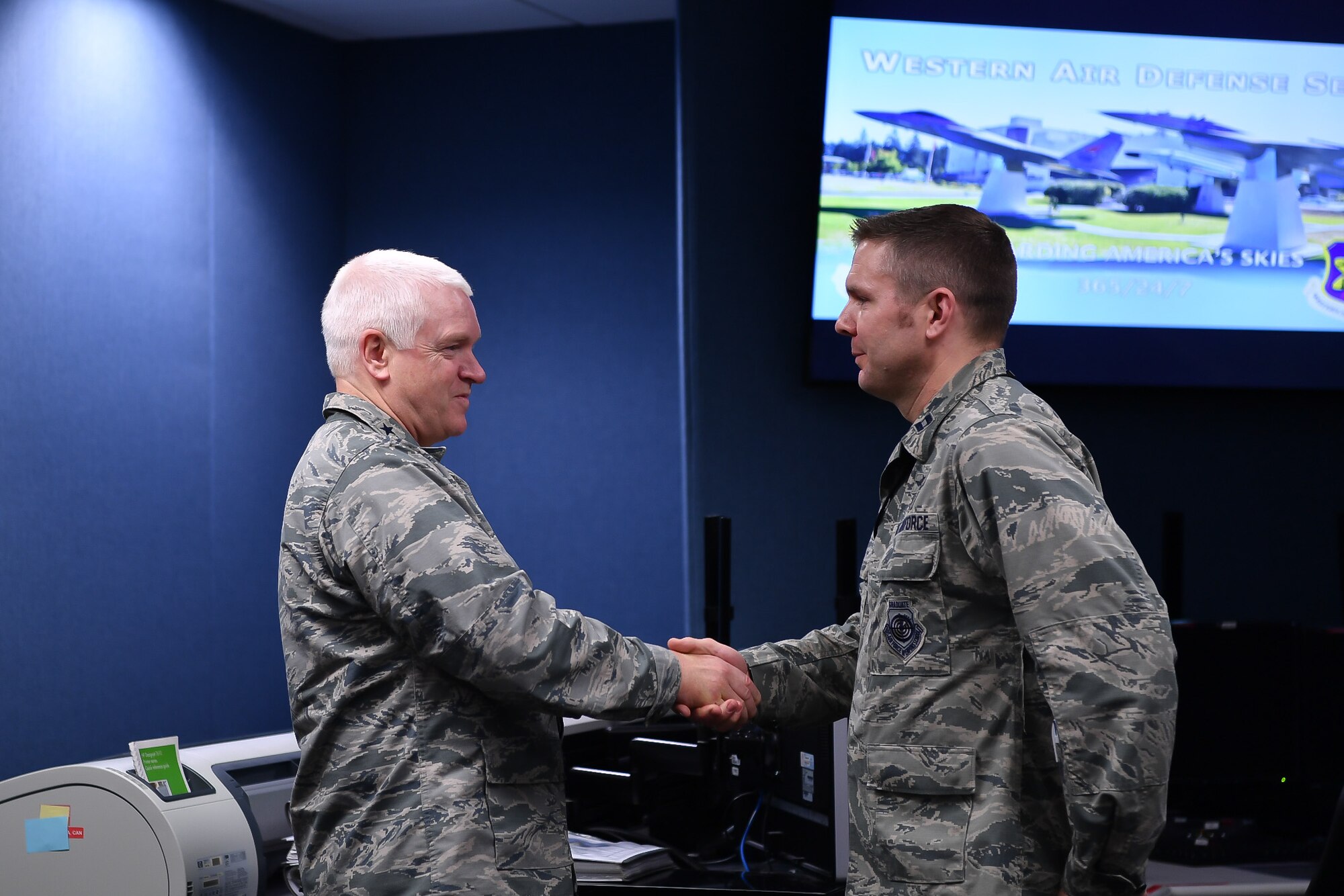 Lt. Gen. L. Scott Rice, Director of the Air National Guard, recognizes Capt. Peter Hickman, 225th Air Defense Squadron, for recently being named a U.S. Air Force Weapons School Top Graduate and First Air Force Command and Control Warrior of the Year.  Rice spent the day visiting two Washington Air National Guard units:  the Western Air Defense Sector at Joint Base Lewis-McChord and the 194th Wing at Camp Murray. (U.S. Air Force photo by Kimberly D. Burke)