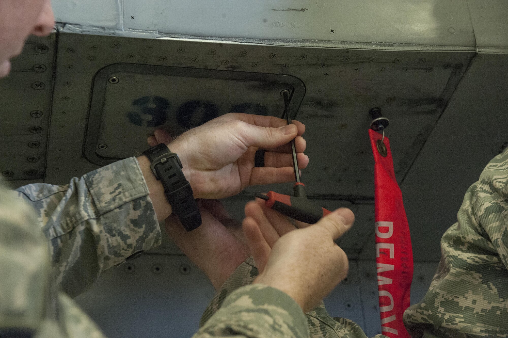 Senior Airman Levi Phillips, a 49th Civil Engineer Squadron Explosive Ordnance Disposal technician, screws a flare back into an F-16 Fighting Falcon at Holloman Air Force Base, N.M. Feb. 14, 2017. Members of the 734th Explosive Ordnance Company EOD team from Fort Bliss, Texas, were given a brief on the aircraft and possible munitions it may have on board. (U.S. Air Force photo by Airman Ilyana A. Escalona)