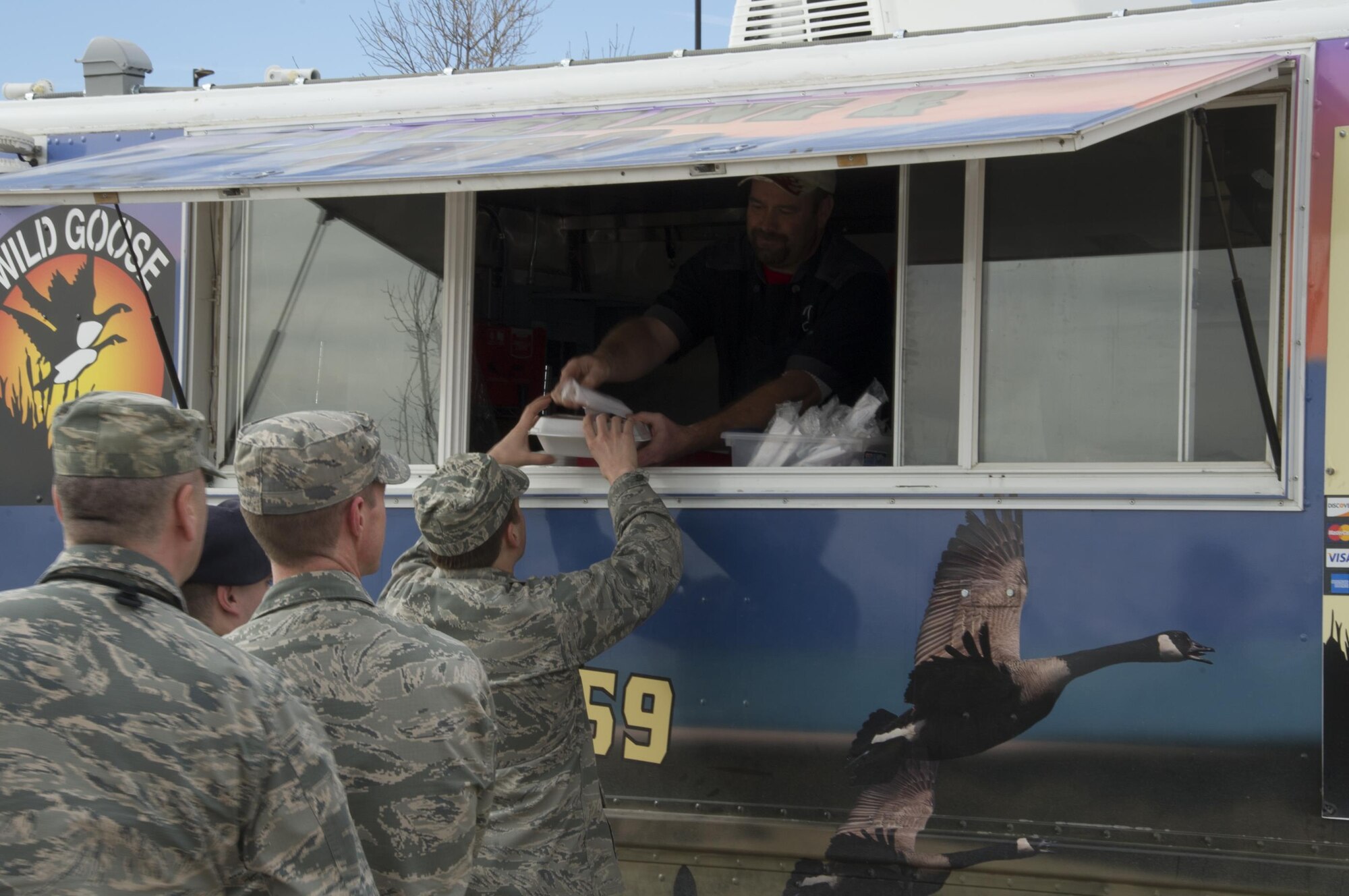 SCHRIEVER AIR FORCE BASE, Colo. -- Vendors at the Wild Goose BBQ food truck serve members of the 310th Space Wing during the Unit Training Assembly on Saturday, Feb. 11th, 2017. With limited food options on Schriever during UTA weekends, the willingness of vendors to provide meal options for Reservists strengthened morale among members of the 310th. (U.S. Air Force photo/Staff Sgt. Chris Moore)