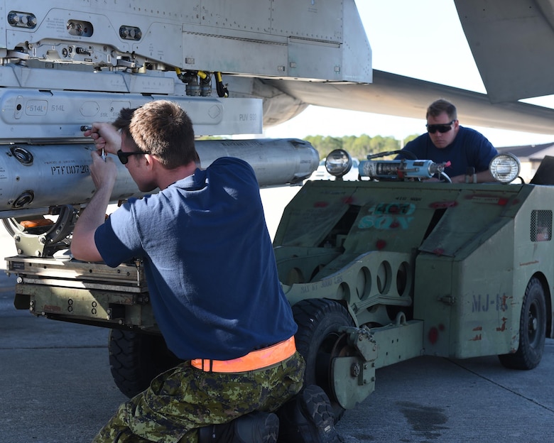 Royal Canadian Air Force weapons systems specialists from the 401st Tactical Fighter Squadron attach a training weapon to a CF-18 Hornet at Tyndall Air Force Base, Fla., Jan. 31, 2017. The Combat Archer and Combat Hammer exercises marked the first time that the 401st TFS deployed a detachment of personnel since fall 2015. (U.S. Air Force photo by Airman 1st Class Cody R. Miller/Released)