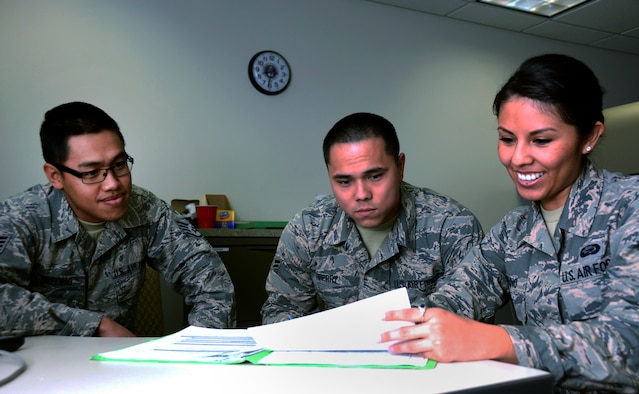 Staff Sgt. Saecho Kao Seng, 349th Force Support Squadron personnel specialist, aids Airmen 1st Class Justin Ferry and Samantha Bambino, 60th Force Support Squadron personnel specialists, in commissioning packages for Airmen assigned to the 349th Air Mobility Wing at Travis Air Force Base, Calif., on Feb. 15, 2017. The 60th and 349th FSS units have been working together to become a seemless unit and Total Force Support Squadron in March. (U.S. Air Force photo/Staff Sgt. Daniel Phelps)