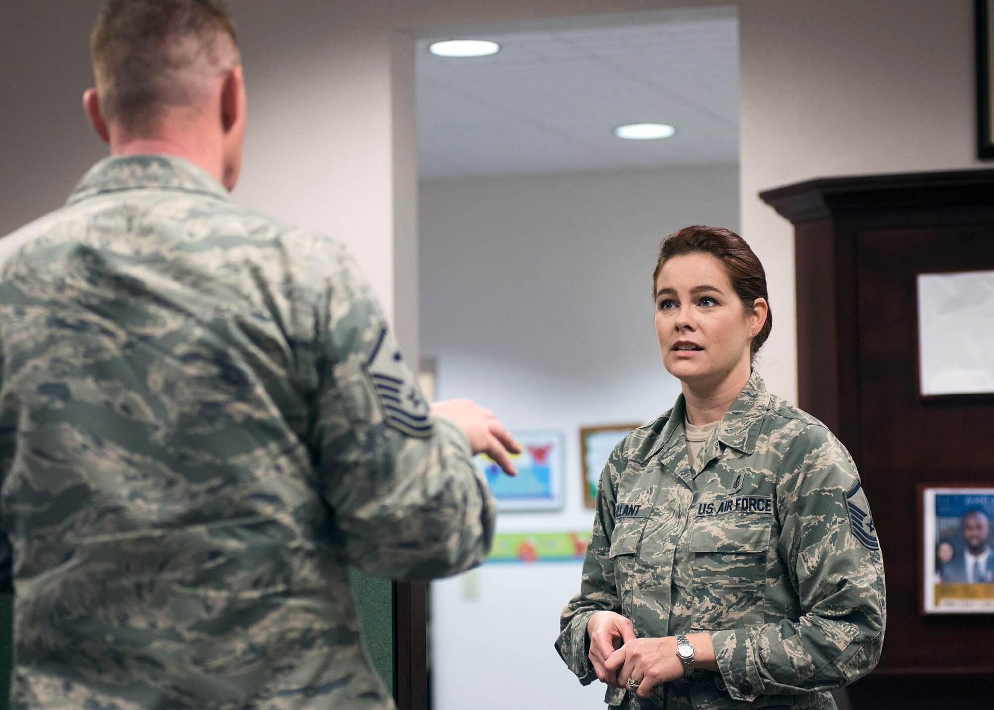 A first sergeant confers with Master Sgt. Erine Gallant, 60th Force Support Squadron Airman and Family Readiness Center superintendent, about a new policy and how it will affect his Airmen during a discussion at the A&FRC at Travis Air Force Base, Calif., Feb. 7, 2017. The A&FRC serves as a focal point for service members and their families to find information on various topics including professional development, financial counseling and employment opportunities. (US Air Force  photo/T.C. Perkins Jr.)