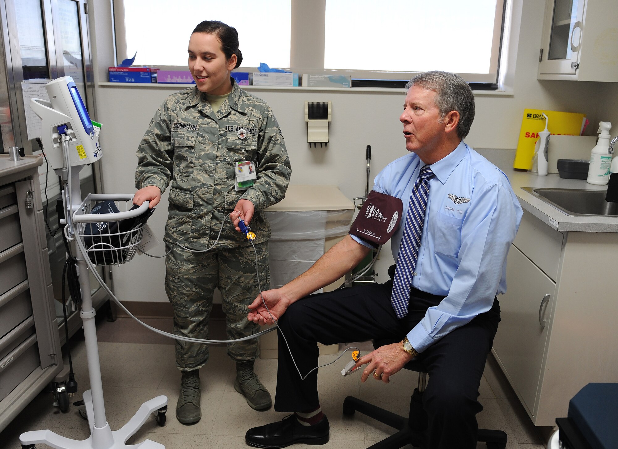 Former Chief Master Sgt. of the Air Force Rodney McKinley gets his blood pressure checked by Airman 1st Class Britney Harrington, a 7th Medical Group aerospace medical technician, during a tour of the 7th MG on Dyess Air Force Base, Texas Feb. 10, 2017. McKinley began his career in 1974 as an emergency room technician at Seymour Johnson AFB, N.C. (U.S. Air Force photo by Airman 1st Class Emily Copeland)