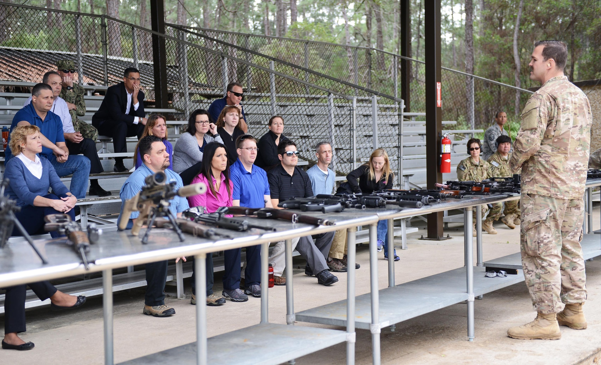 Tech. Sgt. Jarrod Stewart, United States Air Force Special Operations School course director, briefs the United States Special Operations Command Civilian Development group at Hurlburt Field, Fla., Feb. 15, 2017. Stewart demonstrated small-arms weapons capabilities and explained battlefield tactics. (U.S. Air Force photo/Staff Sgt. Melanie Holochwost) 