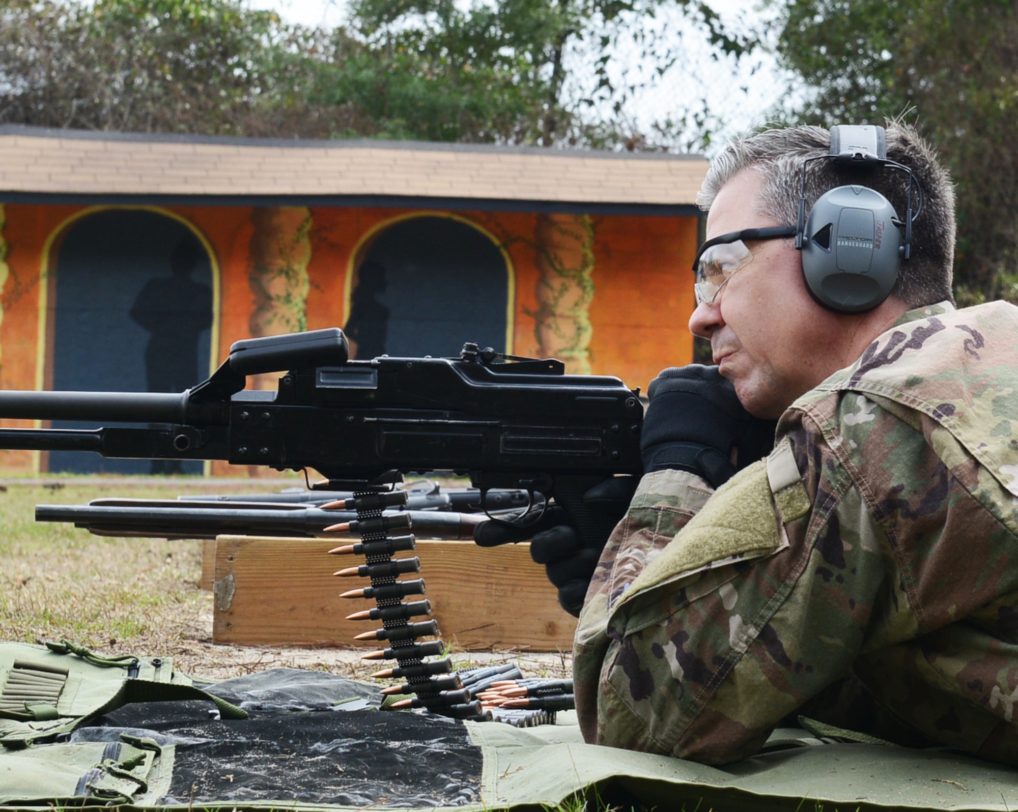 Capt. Daniel Jasper, United States Air Force Special Operations School course director, prepares to fire a Russian PKM Machine Gun at Hurlburt Field, Fla., Feb. 15, 2017. He demonstrated the weapon’s capability to about 15 people going through the Special Operations Command civilian development program. (U.S. Air Force photo/Staff Sgt. Melanie Holochwost)