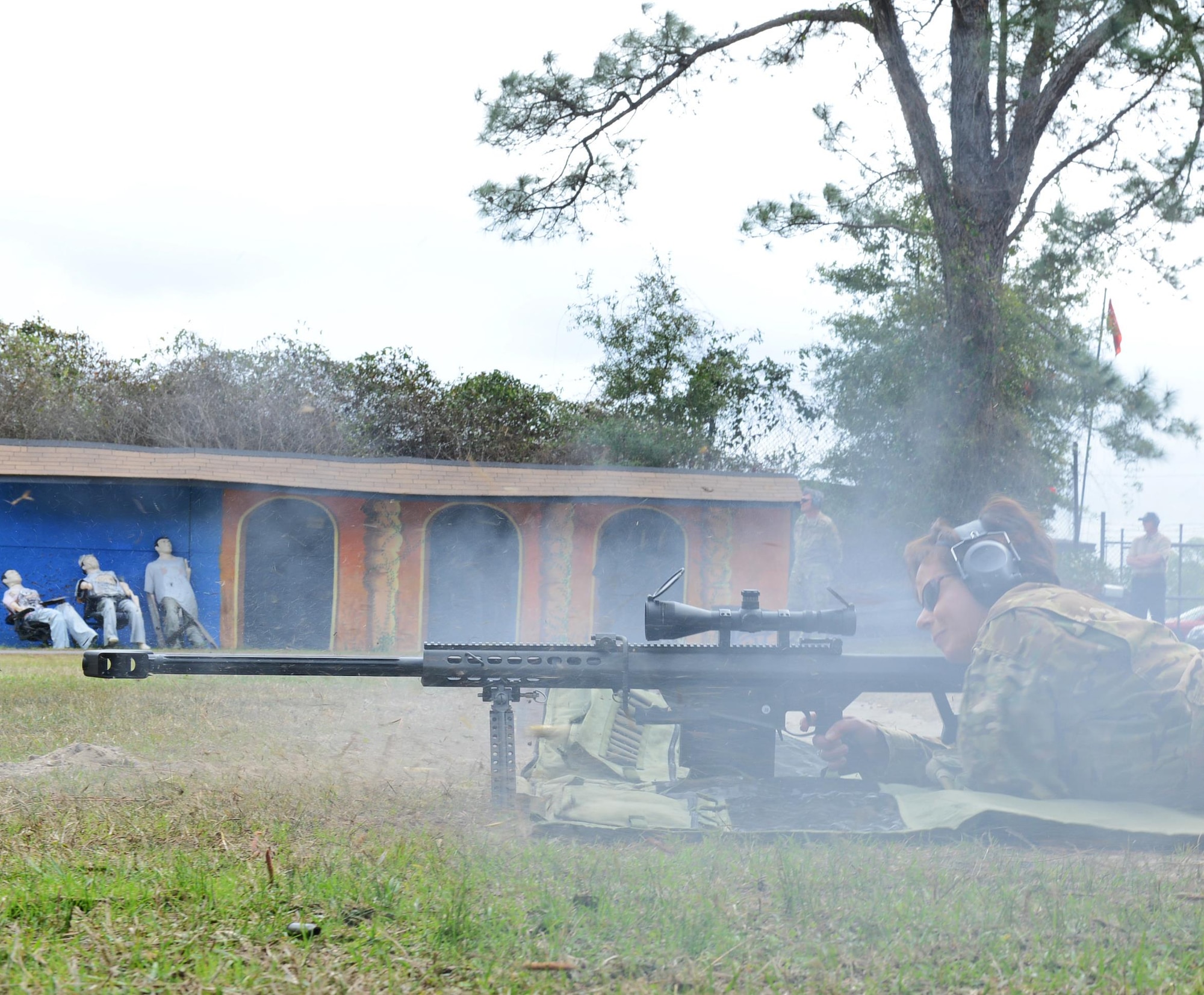 Lori Werth, a graphic artist at the United States Air Force Special Operations School, fires a .50 caliber sniper rifle during a Dynamics of International Terrorism (DIT) demonstration at Hurlburt Field, Fla., Feb. 15, 2017. (U.S. Air Force photo/Staff Sgt. Melanie Holochwost)