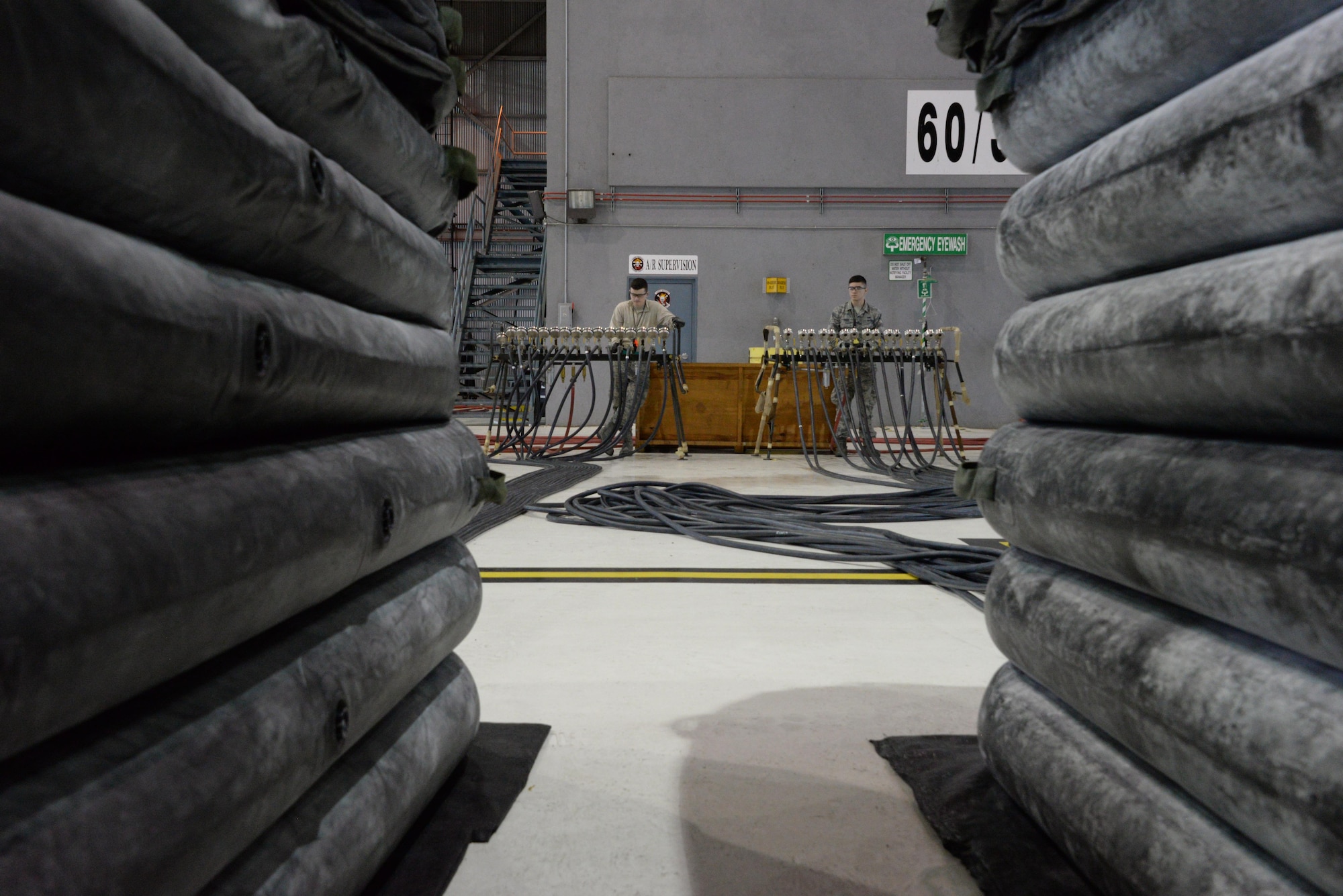 Airmen from the 60th Maintenance Squadron inspect large lifting bags for leaks during an annual quality assurance inspection of the crash, damaged or disabled aircraft recovery program Feb. 9, 2017 at Travis Air Force Base, Calif. The lifting bags, capable of supporting up to 52,000 pounds individually, are used to lift a downed aircraft so it can be salvaged, repaired and recovered.  (U.S. Air Force photo by Senior Airman Amber Carter)