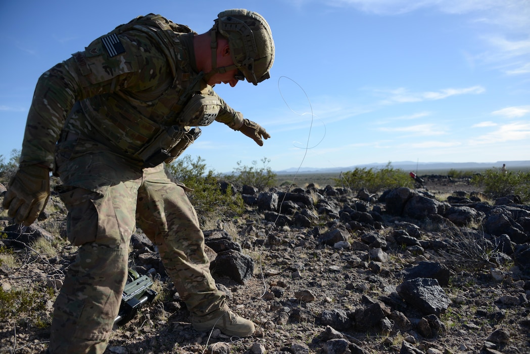 Staff Sgt. Timothy Doland, 56th Civil Engineer Squadron explosive ordnance disposal team leader, remotely moves an object covering roadside bomb during a contingency problem Feb. 8, 2017, at the Barry M. Goldwater Range in Gila Bend, Az.  EOD Airmen remotely move possible roadside bomb threats from a safe distance to avoid potential blasts. (U.S. Air Force photo by Airman 1st Class Alexander Cook) 
