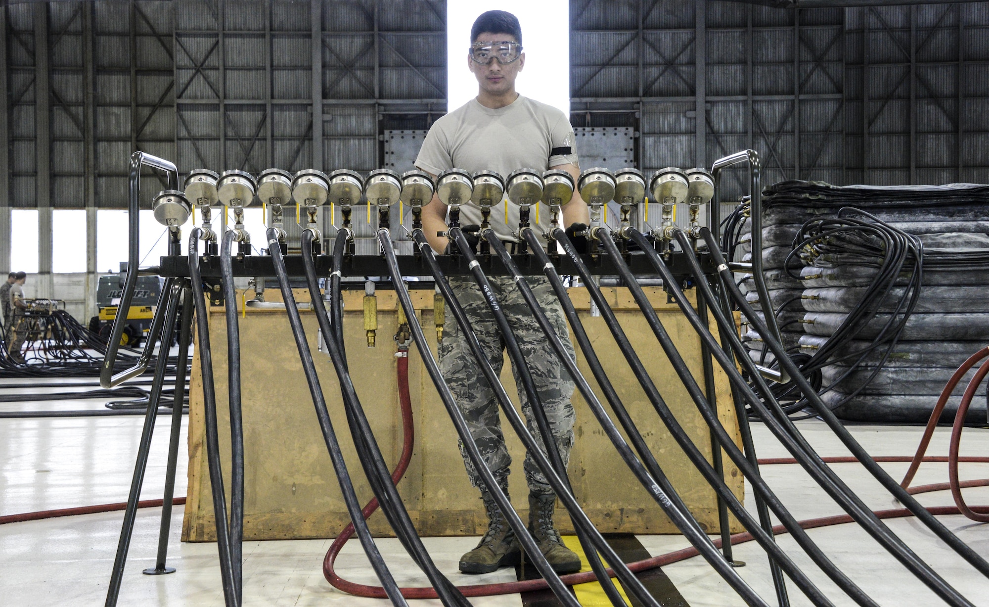 An Airman from the 60th Maintenance Squadron monitors the pounds per square inch while inflating lifting bags during an annual quality assurance inspection of the crash, damaged or disabled aircraft recovery program Feb. 9, 2017 at Travis Air Force Base, Calif. The lifting bags, filled to 7 PSI during the inspection, are used to lift a downed aircraft so it can be salvaged, repaired and recovered.  (U.S. Air Force photo by Senior Airman Amber Carter)