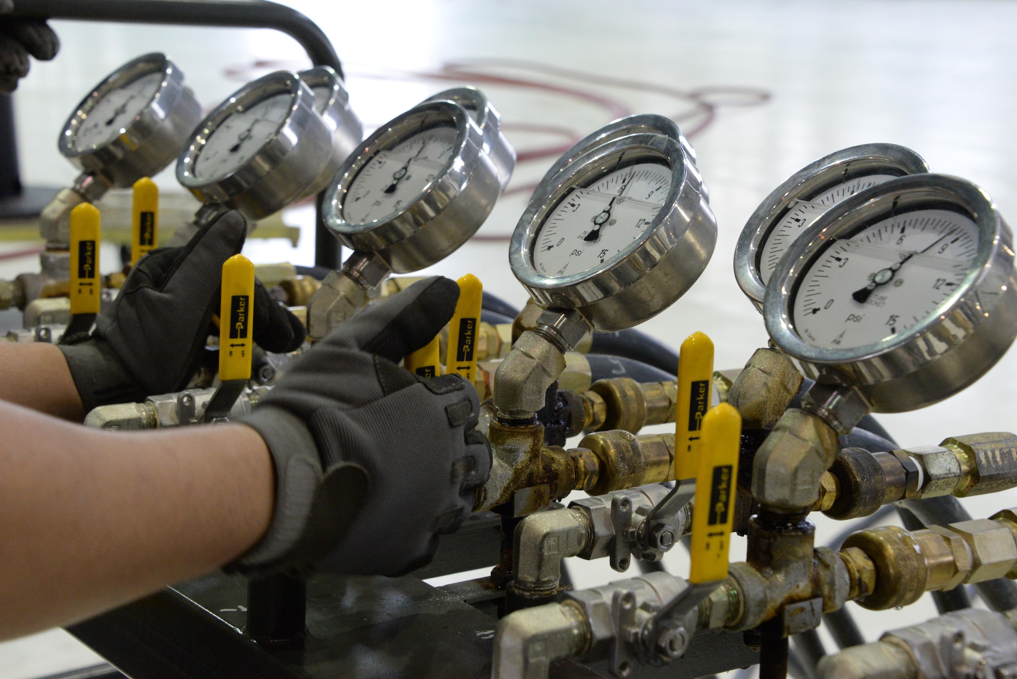 An aero repair technician from the 60th Maintenance Squadron monitors the pounds per square inch while inflating lifting bags during an annual quality assurance inspection of the crash, damaged or disabled aircraft recovery program Feb. 9, 2017 at Travis Air Force Base, Calif. The lifting bags, filled to 7 PSI during the inspection, are used to lift a downed aircraft so it can be salvaged, repaired and recovered.  (U.S. Air Force photo by Senior Airman Amber Carter)