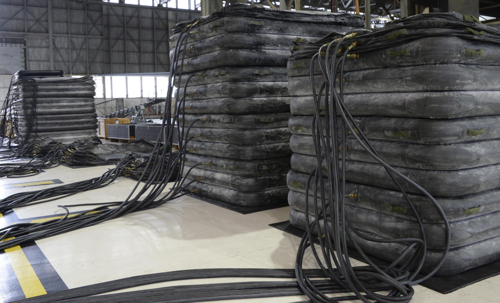 Airmen from the 60th Maintenance Squadron inspect large lifting bags for leaks during an annual quality assurance inspection of the crash, damaged or disabled aircraft recovery program Feb. 9, 2017 at Travis Air Force Base, Calif. The lifting bags, capable of supporting up to 52,000 pounds individually, are used to lift a downed aircraft so it can be salvaged, repaired and recovered.  (U.S. Air Force photo by Senior Airman Amber Carter)