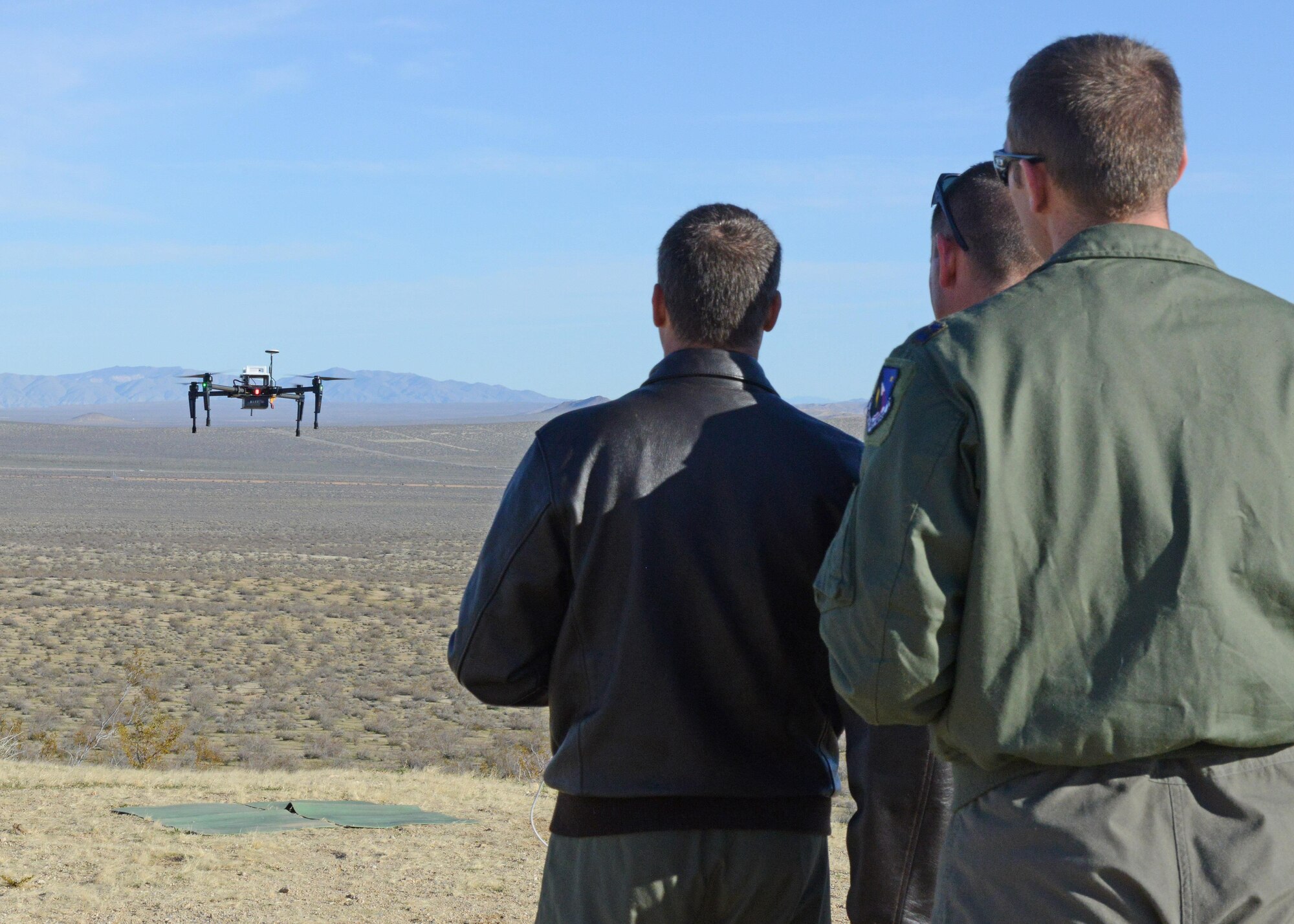 Pilots from the Emerging Technologies Combined Test Force prepare to land a quadcopter after a test sortie Feb. 13. The quadcopter was tested to see if it can perform as a flying radio frequency boresight to calibrate Edwards AFB’s telemetry antennas. (U.S. Air Force photo by Kenji Thuloweit)