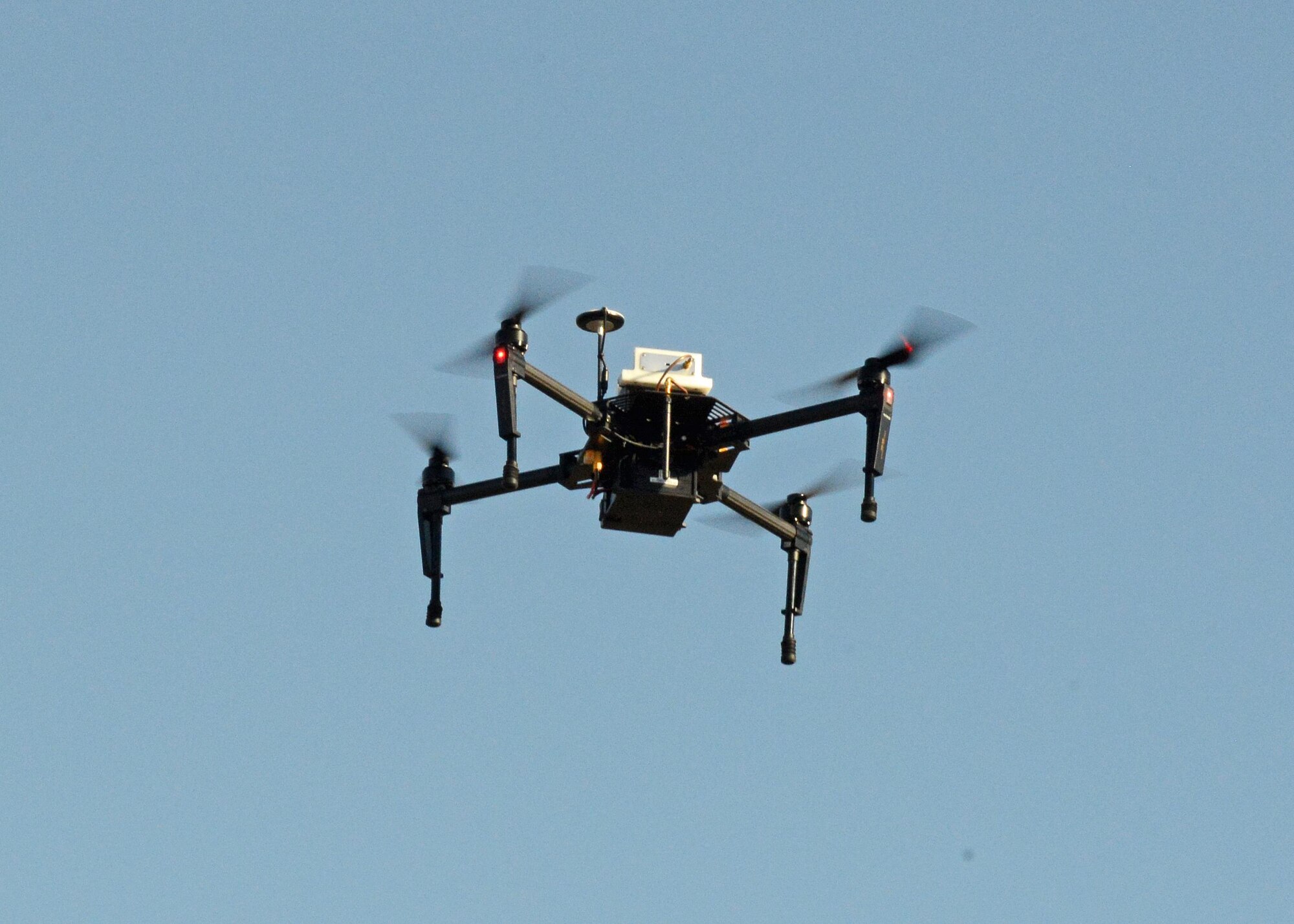 The quadcopter used in the test had GPS stabilization, which makes it “quite easy to pilot.” The aircraft can hover in a fixed position according to applied GPS coordinates. An antenna and transmitter were mounted on the aircraft, which was tested to see if it can be used as a flying radio frequency boresight to calibrate telemetry antennas. (U.S. Air Force photo by Kenji Thuloweit)