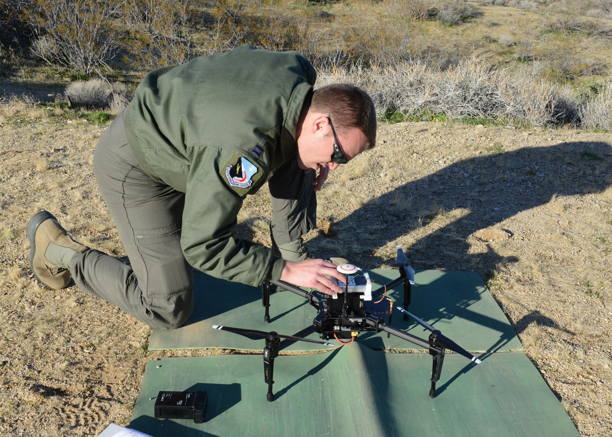 Capt. Justin Merrick, Emerging Technologies Combined Test Force, lead engineer, prepares to power on a quadcopter used during the ET CTF’s first test Feb. 13. (U.S. Air Force photo by Kenji Thuloweit)