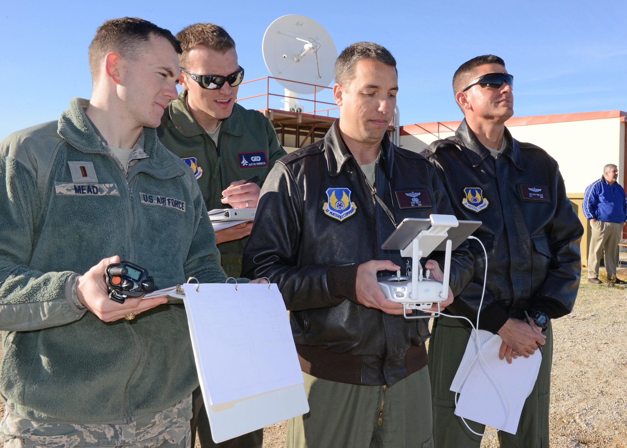 From left to right: 2nd Lt. William Mead, 412th Operations Group; Capt. Justin Merrick, Emerging Technologies Combined Test Force, lead engineer; Maj. Danny Riley, ET CTF director; and Maj. William Niblack, ET CTF operations officer, participated in the first test event for the ET CTF Feb. 13. (U.S. Air Force photo by Kenji Thuloweit)