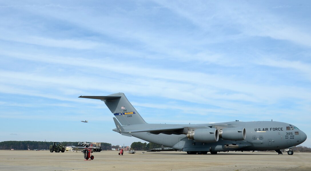 U.S. Air Force and U.S. Coast Guard personnel prepare to load a security boat on a C-17 Globemaster III at Joint Base Langley-Eustis, Va., Feb. 8, 2017. The Coast Guardsmen assigned to the Port Security Unit 305 loaded the plane in preparation to deploy. (U.S. Air Force photo by U.S. Airman 1st Class Kaylee Dubois)