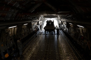 U.S. Air Force and U.S. Coast Guard personnel load a security boat on a C-17 Globemaster III at Joint Base Langley-Eustis, Va., Feb. 8, 2017. The C-17 Globemaster III assigned to Joint Base McGuire-Dix-Lakehurst, N.J. transported the Coast Guardsmen and their equipment to their deployed location. (U.S. Air Force photo by U.S. Airman 1st Class Kaylee Dubois)