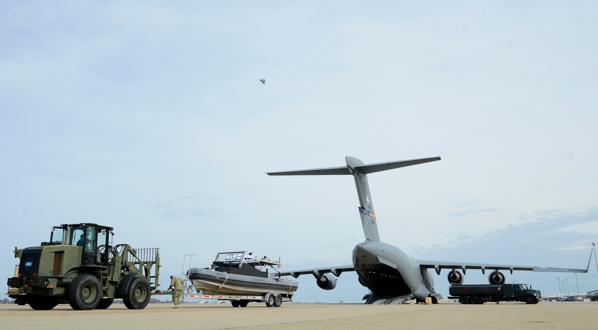 U.S. Coast Guard Aviation Electrician 2nd Class Garrett Conol, Port Security Unit 305 crewmember, secures a security boat to a forklift before loading it onto a C-17 Globemaster III at Joint Base Langley-Eustis, Va., Feb. 8, 2017. The Port Security Unit 305 will perform shore and water-side security during a joint task force deployment. (U.S. Air Force photo by U.S. Airman 1st Class Kaylee Dubois)