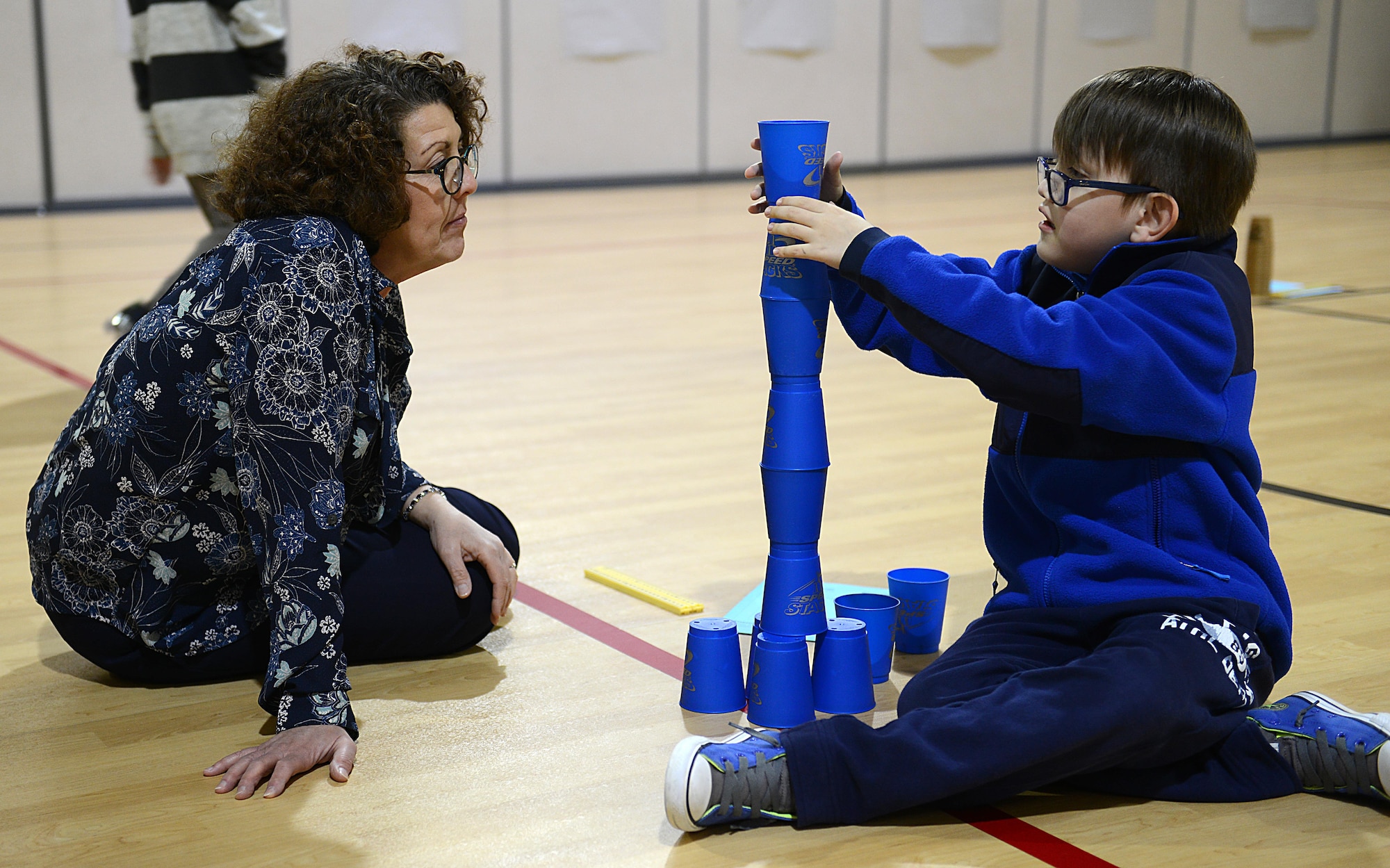 Pandora Howell, 733rd Civil Engineer Division portfolio optimization chief, provides guidance as Ralph Belford, VI, age eight, son of U.S. Army Sgt. 1st Class Ralph Belford, V, Army Training Support Center NCO, builds a tower during the Family science, technology, engineering and mathematics Night event at Gen. Stanford Elementary School at Joint Base Langley-Eustis, Va., Feb. 9, 2017. Architectural and design professionals attended the event to help students understand how math, height and stability work together when building tall towers. (U.S. Air Force photo by Staff Sgt. Teresa J. Cleveland)