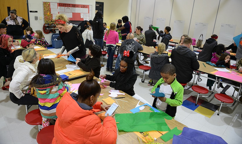 Teachers, U.S. Army Soldier volunteers, family members and students work to build gliders during the Family science, technology, engineering and mathematics Night event at Joint Base Langley-Eustis, Va., Feb. 9, 2017. Soldiers and teachers worked with children to demonstrate how engineering and design play important roles in future careers and education goals. (U.S. Air Force photo by Staff Sgt. Teresa J. Cleveland)