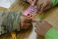 U.S. Army Master Sgt. Cassandra Alam, McDonald Army Health Center operations NCO, partners with Nathan Branch, age six, during the Family science, technology, engineering and mathematics Night event at Joint Base Langley-Eustis, Va., Feb. 9, 2017. During this activity, children and volunteers worked to solve problems and rescue gummy worms from a simulated drowning. (U.S. Air Force photo by Staff Sgt. Teresa J. Cleveland)