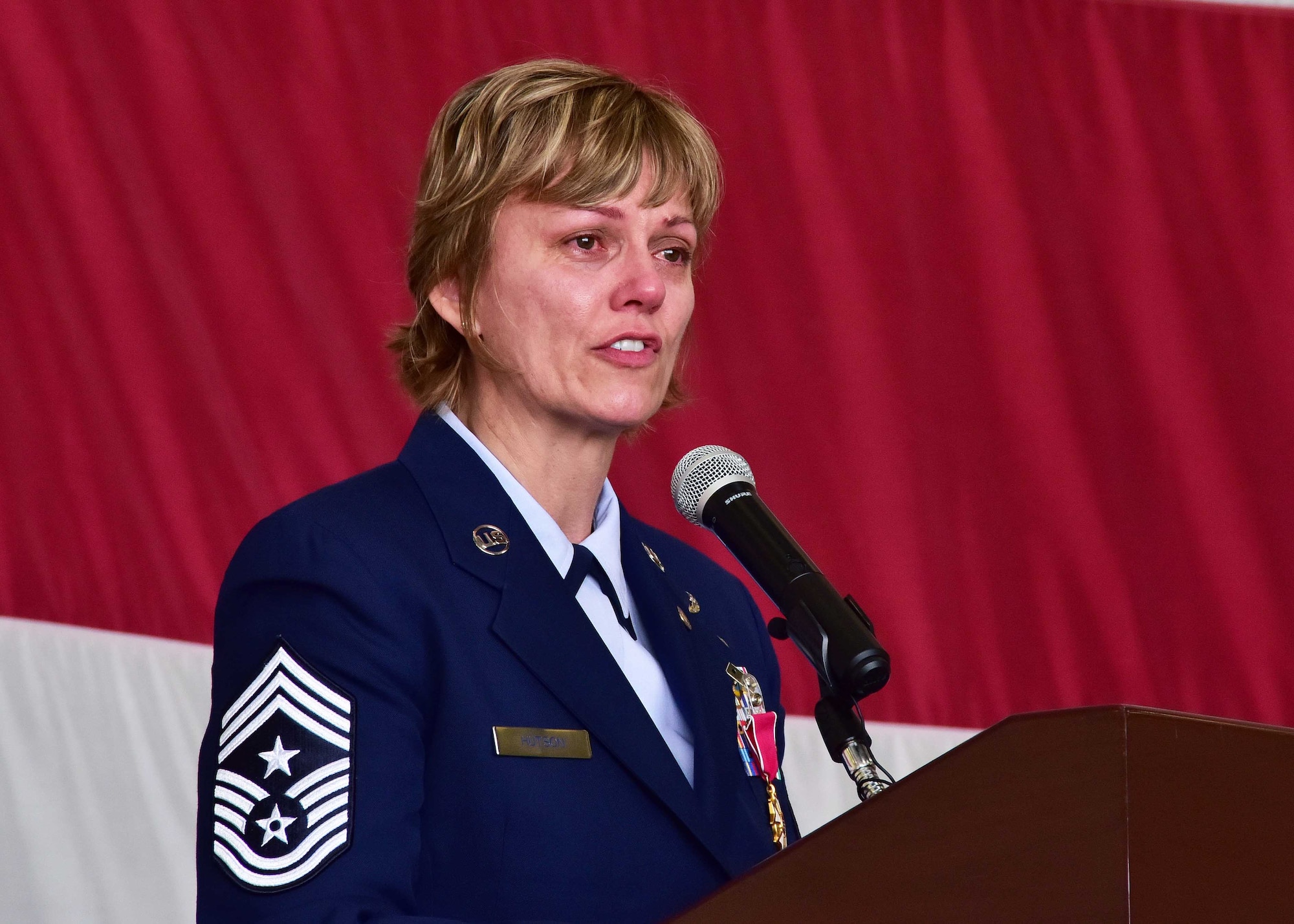 Chief Master Sgt. Rhonda Hutson, 944th Fighter Wing command chief, gives her final remarks to family, friends and wing members Feb. 12 during her retirement ceremony at Luke Air Force Base, Ariz. (U.S. Air Force photo by Tech. Sgt. Louis Vega Jr.)