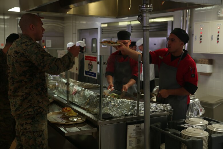 U.S. Marine Corps Lance Cpl. Keyon Dummer Williams, a food service specialist, serves a Mongolian dish during Mongolian Bar Wednesday in the R.G. Robinson Mess Hall at Marine Corps Air Station Iwakuni, Japan, Feb. 8, 2017. Mongolian Bar Wednesday was started in an effort to attract more patrons to the mess halls by offering specialty meals such as the Mongolian Bowl. (U.S. Marine Corps photo by Lance Cpl. Carlos Jimenez.)