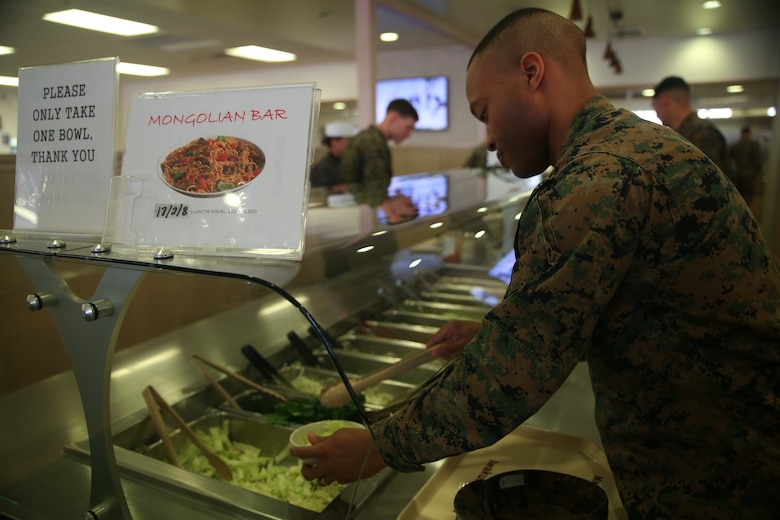 U.S. Marine Corps Staff Sgt. Michael Parrish, a warehouse clerk with Marine Aircraft Group 12, chooses from the Mongolian-themed salad bar during Mongolian Bar Wednesday in the R.G. Robinson Mess Hall at Marine Corps Air Station Iwakuni, Japan, Feb. 8, 2017. Mongolian Bar Wednesday was started in an effort to attract more patrons to the mess halls by offering specialty meals such as the Mongolian Bowl. (U.S. Marine Corps photo by Lance Cpl. Carlos Jimenez)