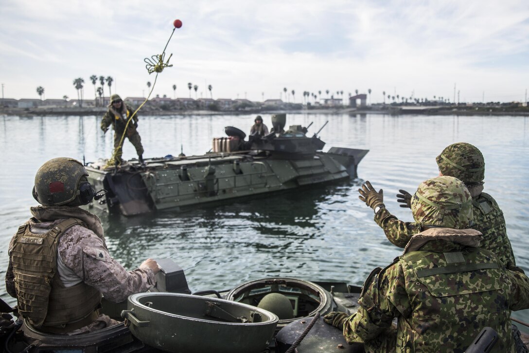 A U.S. Marine and soldiers assigned to the Japanese Ground Self-Defense Force practice recovering an assault amphibious vehicle during Exercise Iron Fist 2017 at Marine Corps Base Camp Pendleton, Calif., Feb 13, 2017. Marines taught the Japanese soldiers how to operate the amphibious vehicles. The exercise enabled U.S. and Japanese service members to share techniques, tactics and procedures to improve their combined operational capabilities. Marine Corps photo by Cpl. Alvin Pujols